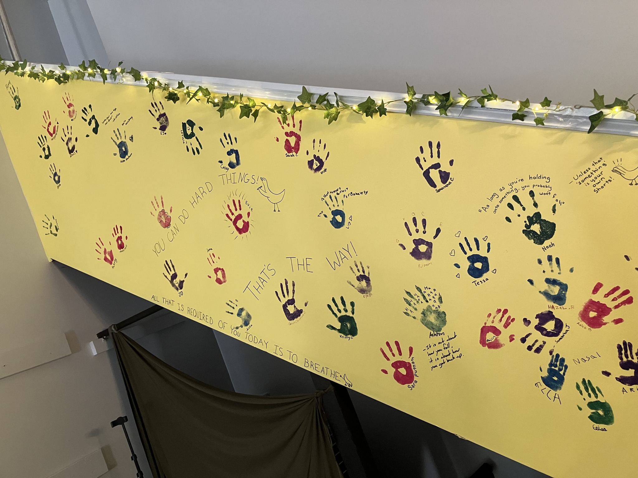 Community handprint wall at Ducking Gravity studio